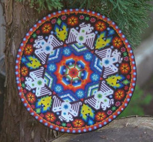 This ceremonial bowl is crafted from a dried gourd and covered with beadwork icons. Robert Otey, 1997