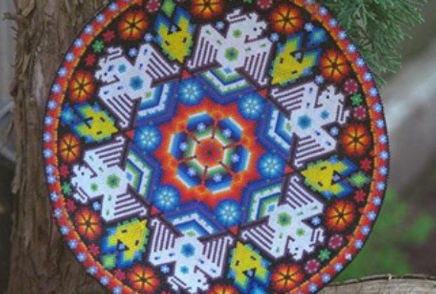 This ceremonial bowl is crafted from a dried gourd and covered with beadwork icons. Robert Otey, 1997