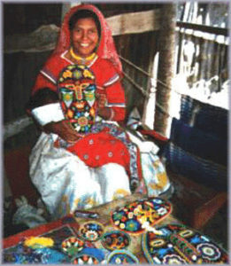 A Huichol woman in Mexico crafts a ceremonial mask © Robert Otey, 1997