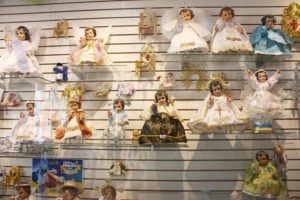 El Dia de la Candelaria, or Candlemas, commemorates little Jesus' presentation in the temple, according to Hebrew custom. In Mexico, the image of the Christ child from the family's nativity scene receives new clothing for the occasion. This shop in Oaxaca displays a number of ready-made outfits. © Tara Lowry, 2014