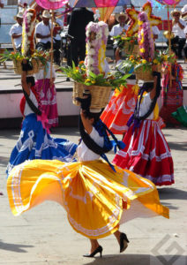 Dancers hold baskets with floral offerings on their heads as part of Oaxaca's celebrated Guelaguetza festivities. © Oscar Encines, 2008