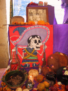 Elaborate altars line covered corridors that wrap around Oaxaca City's main cemetery. Most families also have a private altar in their home, with food, flowers, candles and mementos.
