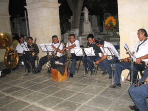 During the evening, musical groups entertain visitors to El Panteón, which attracts more tourists than cemeteries in neighboring villages. The events in the main cemetery are staged for visitors, even though Day of the Dead is not a holiday for tourists. Since the traditions and celebrations of Day of the Dead fascinate foreigners, tourists increasingly flock to Oaxaca's cemeteries.