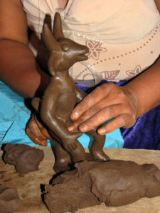 Shaped by hand of clay, a whimsical goat comes to life in the hands of Antonia Cruz Rafael. Ocumicho in the Mexican state of Michoacan is known for its hand-crafted ceramics. © Travis Whitehead, 2009