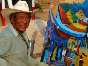 A local artist sets up his easel near the beach in Sayulita. His colorful canvas captures the charm of this town on Mexico's Nayarit Riviera. © Christina Stobbs, 2009