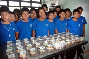 The boys apply their decorating skills to carrot cakes for a Crafts Fair. They are residents of Villa de los Niños near Guadalajara, Mexico. © John Pint, 2012