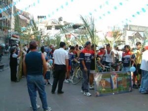 A group of bicyclists display their banner that reads, "San Juan la Isla, Estado de Mexico"