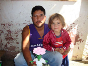 Within the walls of the Oaxaca State Prison, some inmates and their visitors are free to move about at will in certain areas. Many prisoners have their families with them throughout the day, as seen in this father-child portrait. © John McClelland, 2010