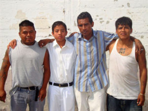 An inmates son is dressed in white to receive his first communion from the prison chaplain, Reverend Spencer Thompson. In the Oaxaca State Prison, family life continues unabated. Wives, children, girl friends, mothers and fathers all try to maintain the family in spite of the restrictions. © John McClelland, 2010