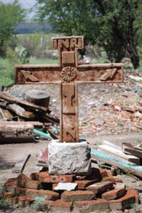 An old Mexican stone cross of mixed imagery © John Scherber, 2012