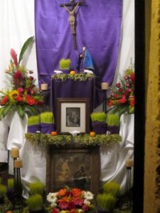 A crucifix against purple satin -- the color represents Christ's passion -- crowns an elaborate and beautiful Mexican Altar de Dolores © Edythe Anstey Hanen, 2014