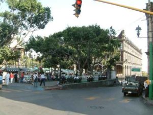 The centrally located Jardin Juarez is probably the busiest plaza in the city when there is no demonstration in the zocalo. Snack food is sold everywhere here. Left looking south down Galeana street the Palacio Gobierno is the portaled building. Cuernavaca, Morelos © Rick Meyer 2006