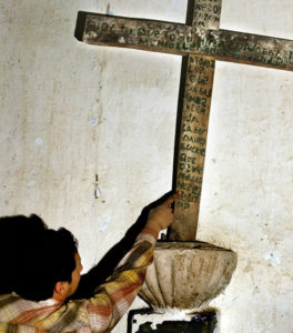 Archeologist Rodrigo Esparza studies an ancient inscription inside the chapel at Hacienda Labor de Rivera in the Mexico state of Jalisco. © John Pint, 2011