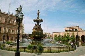 A fountain sits in the center of the Plaza de Armas in front of the Cathedral of Santiago in Saltillo.