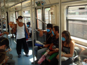 Hawkers and passengers alike take no chances on Mexico City's Metro. Virtually everyone wears a facemask. © Anthony Wright, 2009