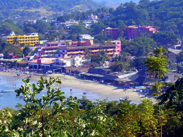 The beach of Rincon de Guayabitos beach offers shallow safe swimming waters, gentle waves that are perfect to play in, and three miles of fine, velvety sand. Comfortable hotels and condos line this part of Mexican Pacific. © Christina Stobbs, 2009