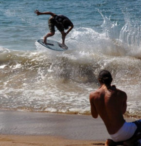 Silled as many champions, a A young Mexican skimboarder catches a wave on the shore of Melaque, Jalisco. © Gerry Soroka, 2010