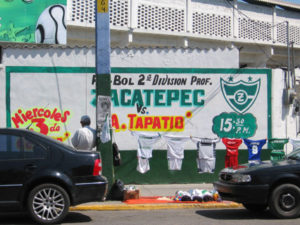A man selling Cañeros tee shirts. The Cañeros – "Sugar Caners" – are the local Mexican soccer team. © Julia Taylor, 2008