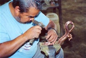 Abdon Punzo Angel works on copper dragons in his shop in Santa Clara del Cobre.