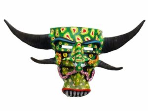 Two sets of horns and eyes eppear on this enigmatic mask. By Prudencio Guzman, a ceramicist and mask artisan from Tonala, Jalisco, it is named "Duality." This is a Tastoan mask, worn by costumed dancers who battle Saint James each year on July 25th. © Kinich Ramirez, 2006