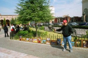 A man sells his brother's paintings in the Plaza de Armas in Saltillo.