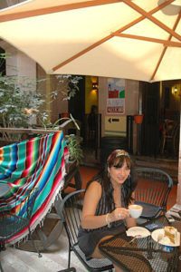 Liliana Fernandez sips coffee at San Patricio Café in the historic district of Zacatecas. The café with its center courtyard, is a place for people to retreat from the heat of the day.