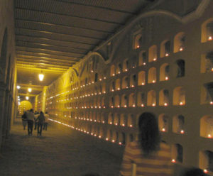 Walls of the corridors at El Panteón contain crypts, each with a place for a candle. 'Lighting of the candles' ceremony is one of the public events that draws large crowds during Day of the Dead.
