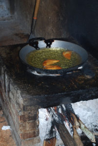 Empanadas — masa or corn dough disks filled with squash — sizzle in hot oil. They will be served during the Day of the Dead celebration in Pac Chen, a Maya village in the jungle of Quintana Roo. © Jane Ammeson, 2009