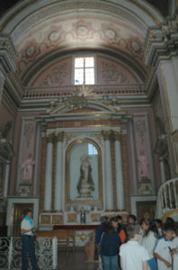 A painting of Our Lady of Guadalupe encased in an 18 carat gold frame and flanked by gleaming white pillars and side panels of gold and pink is the center in a room filled with gilt, statuary, candelabras and an extremely ornate altar. The Sanctuary of Our Lady of Guadalupe in Zacatecas dates back to the early 1700s. © Jane Ammeson, 2009