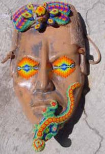 Huichol artisan Kupíha'ute-Itzpapalotl brings his culture's icons to a Maya mask. © Erin Cassin, 2006