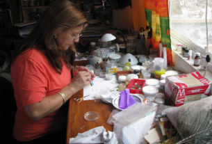 Jars and bags full of feathers clutter Martha's desk. A dizzying array of colors -- pale green and cerulean blue and chocolate and raw umber -- clamor for attention.