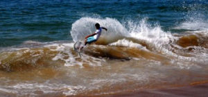 A Mexican youth rides his skimboard with grace and skill on the shore of Melaque, Jalisco. © Gerry Soroka, 2010