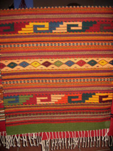 This handwoven Zapotec wool rug is a creation of the Santiago family of Teotitlan del Valle, Oaxaca. The motif is named "Fiesta." © William Ing, 2007