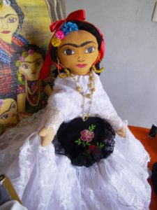This handcrafted Frida Kahlo doll wears a traditional Mexican dress of extravagant white lace with golden beads and earrings © Alvin Starkman, 2012