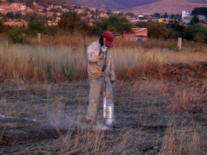 Pacing off the dimensions, a man uses chalk to show where foundations go. © Norma Hawthorne 2008