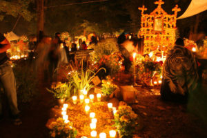 In the cemetery, thousands of candles are vigilantly kept lit throughout the night by celebrating families.