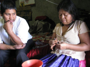 Antonia Cruz Rafael of Ocumicho, Michoacan is a skilled ceramist. She shapes a clay image by hand while her husband Jose watches with admiration. © Travis Whitehead, 2009