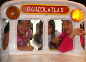Three little girls in a toy bus during the Christmas posadas in Los Aala. The Mexican Pacific coast town remains one of Mexico's best kept secrets. © Christina Stobbs, 2011