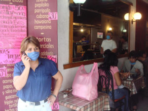 A concerned restaurant owner talks on the phone, a day before all restaurants were closed down in Mexico City. © Anthony Wright, 2009