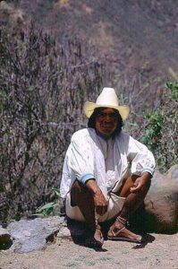 Even with my high tech hiking boots, I was unable to keep up with my Tarahumara guide as he took me along narrow trails in Mexico's rugged Copper Canyon. He had many opportunities to sit and wait for me to catch up. © Geri Anderson 2001.