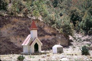 Most food products and other goods must be hauled to the Copper Canyon town of Batopilas by truck. At the bottom of the most treacherous inclines are small shrines where truckers stop and give thanks with a prayer or lighted candle. © Geri Anderson 2001.