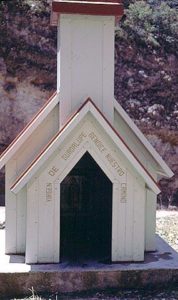 Roads in the Copper Canyon of Mexico are narrow and sinuous. At the bottom of the most treacherous inclines are small shrines where truckers stop and give thanks with a prayer or lighted candle. The shrine bears the words "Virgen de Guadalupe Bendice Nuestro Camino." © Geri Anderson 2001.