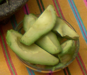 Fresh avocado makes a great garnish for chilaquiles. Their buttery texture is a perfect counterpoint to the crisp tortilla bites, and the cool flavor helps put out the fire in your mouth. © Daniel Wheeler, 2009