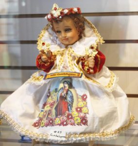 This figurine depicting Baby Jesus in a Oaxaca market wears an ornate gown with the image of the Virgin of Guadalupe © Tara Lowry, 2014
