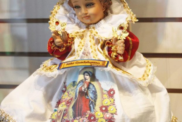 This figurine depicting Baby Jesus in a Oaxaca market wears an ornate gown with the image of the Virgin of Guadalupe © Tara Lowry, 2014