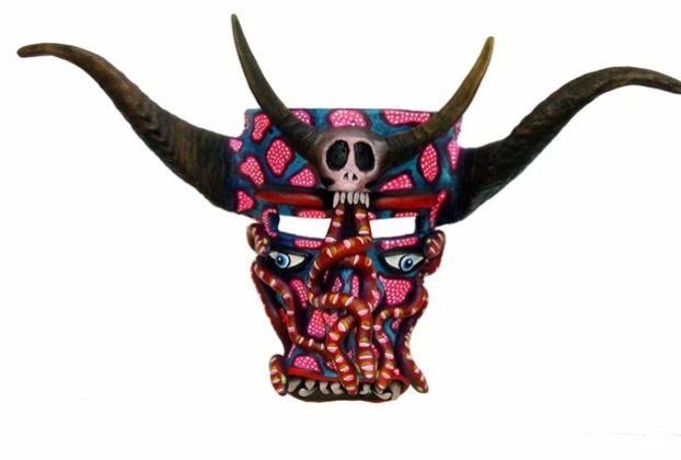 Serpents writhe on a fierce horned mask by Tonala artisan Prudencio Guzman. He names this design "The Death of Ambition." Costumed Tastoanes in frightening masks battle Saint James in a ritual dance each year on July 25th. © Kinich Ramirez, 2006