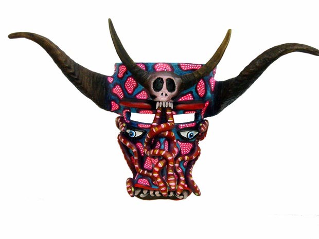 Serpents writhe on a fierce horned mask by Tonala artisan Prudencio Guzman. He names this design "The Death of Ambition." Costumed Tastoanes in frightening masks battle Saint James in a ritual dance each year on July 25th. © Kinich Ramirez, 2006