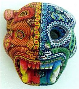 Huichol artisan pholosopher Kupíha'ute-Itzpapalotl explores the Nawatl concept of duality with this beadwork mask depicts a juaguar and a skeleton jaguar. © Erin Cassin, 2006
