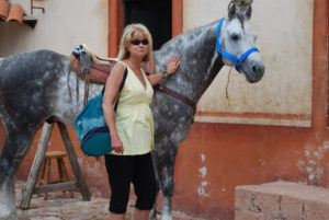 Author Jane Ammeson pats Tlaloc, named for the God of Rain and a national champion, at Los Azteca Hacienda Mexicana. Horses can be rented to ride from Los Azteca to Bernal, Querétaro for lunch. © Jane Ammeson 2009