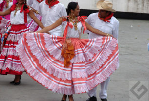 Women from the coast of the Tehuantepec Isthmus wear embroidered blouses and full, lacy skirts. The men wear white. These dancers perform during Oaxaca's annual Guelaguetza celebration in July. © Oscar Encines, 2008